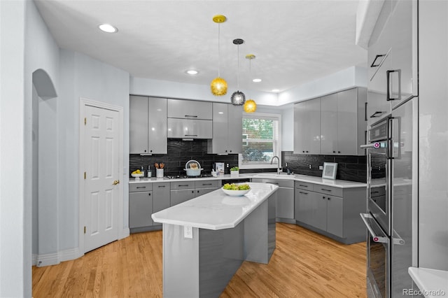222 S Olive St, Denver, CO 80230 - kitchen with gray cabinetry, modern cabinets, backsplash, hanging light fixtures, and recessed lighting
