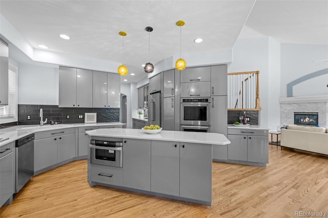 222 S Olive St, Denver, CO 80230 - kitchen featuring gray cabinetry, appliances with stainless steel finishes, a center island, tasteful backsplash, and recessed lighting