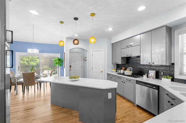 222 S Olive St, Denver, CO 80230 - kitchen featuring gray cabinetry, stainless steel appliances, tasteful backsplash, decorative light fixtures, and a center island