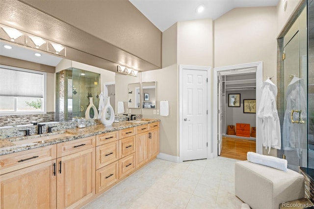 222 S Olive St, Denver, CO 80230 - full bathroom featuring double vanity, a shower stall, high vaulted ceiling, and tile patterned floors