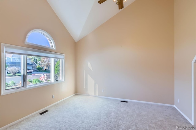 carpeted empty room featuring a ceiling fan, baseboards, and high vaulted ceiling