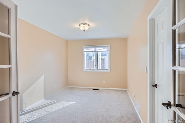carpeted spare room with baseboards