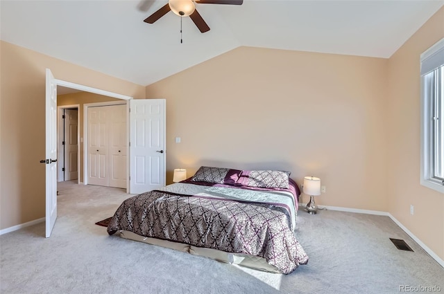 bedroom with carpet flooring, vaulted ceiling, a ceiling fan, and baseboards