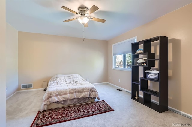 carpeted bedroom featuring baseboards and ceiling fan