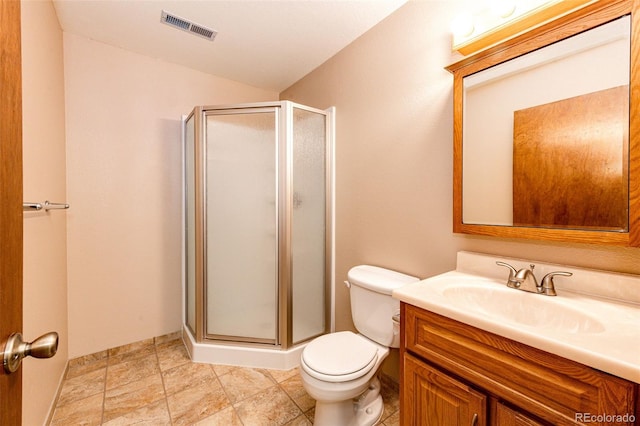 bathroom with walk in shower, vanity, and toilet