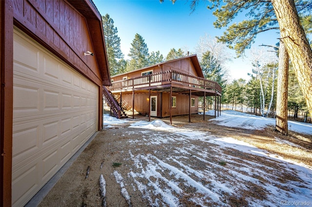 exterior space with a wooden deck and a garage