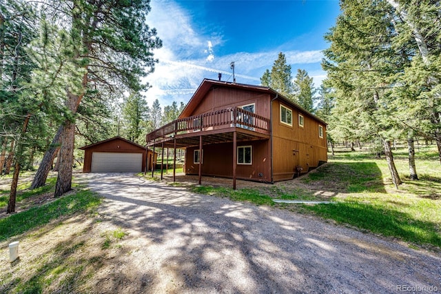 224 Yellow Pine Dr, Bailey, CO 80421 - chalet / cabin featuring an outbuilding, a wooden deck, and a detached garage