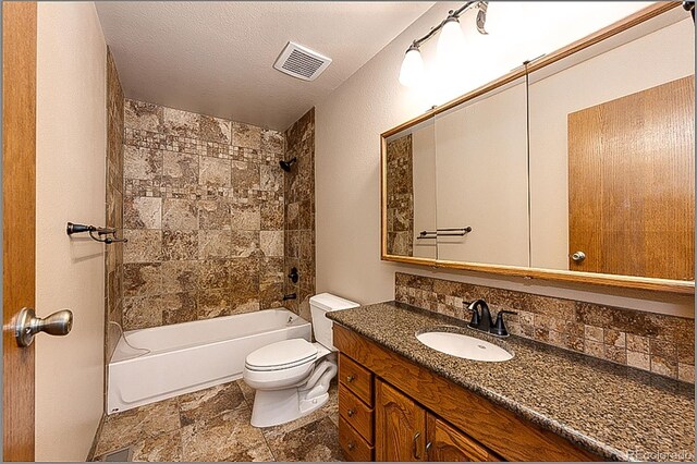224 Yellow Pine Dr, Bailey, CO 80421 - bathroom featuring vanity, toilet, bathtub / shower combination, backsplash, and stone finish floors