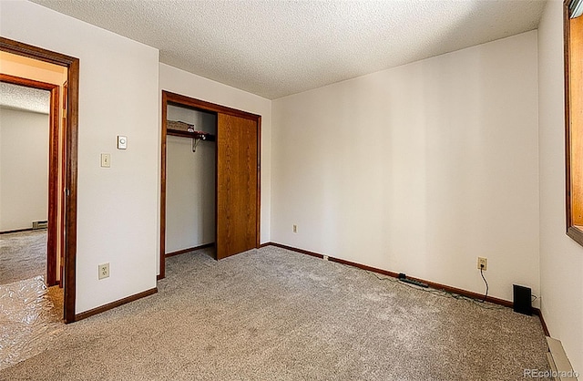224 Yellow Pine Dr, Bailey, CO 80421 - unfurnished bedroom with carpet flooring, a closet, a textured ceiling, and baseboards