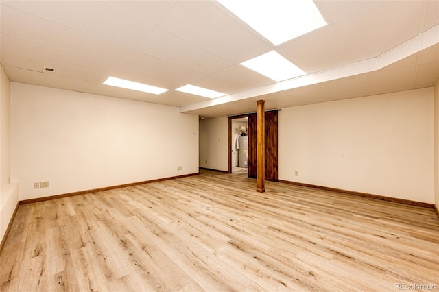 224 Yellow Pine Dr, Bailey, CO 80421 - unfurnished room with light wood-type flooring, water heater, baseboards, and a paneled ceiling