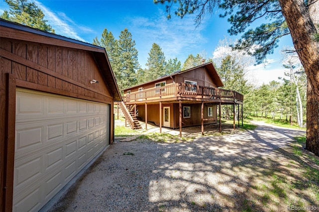 224 Yellow Pine Dr, Bailey, CO 80421 - view of front of house featuring stairway, a deck, a garage, and driveway