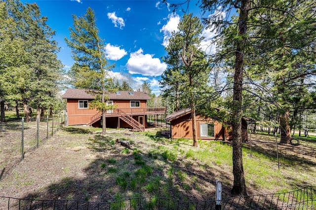 224 Yellow Pine Dr, Bailey, CO 80421 - rear view of property featuring stairway, a deck, and a fenced backyard