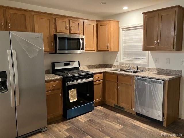 kitchen with stainless steel appliances, sink, and dark hardwood / wood-style flooring