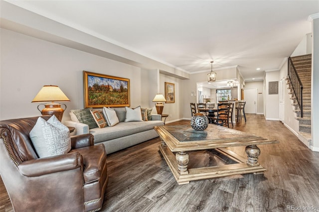 living room with baseboards, wood finished floors, and stairs