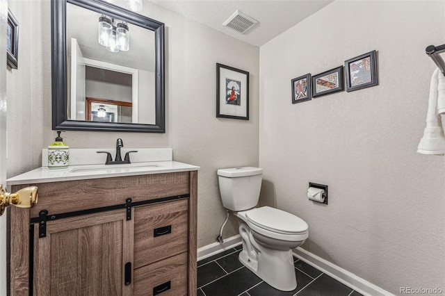 half bath with visible vents, baseboards, toilet, tile patterned floors, and vanity