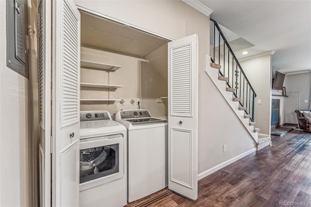 washroom with dark wood-style floors, baseboards, washing machine and clothes dryer, laundry area, and ornamental molding