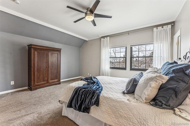 carpeted bedroom featuring baseboards, ceiling fan, ornamental molding, and vaulted ceiling