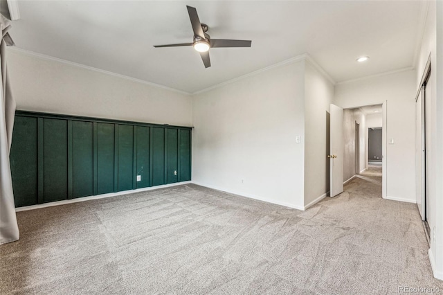 spare room featuring baseboards, recessed lighting, ceiling fan, light carpet, and crown molding