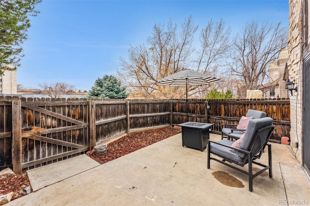 view of patio / terrace with an outdoor fire pit and a fenced backyard