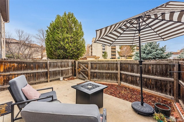 view of patio with a fenced backyard and an outdoor fire pit