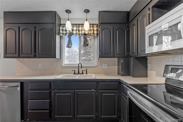 kitchen featuring range with electric stovetop, dishwasher, sink, decorative backsplash, and a textured ceiling