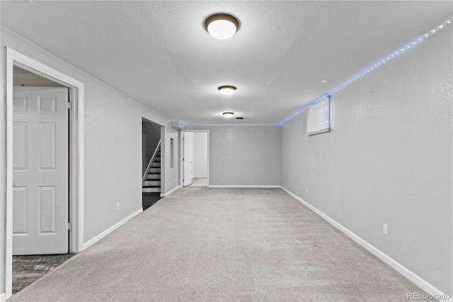 basement with a textured ceiling and carpet flooring