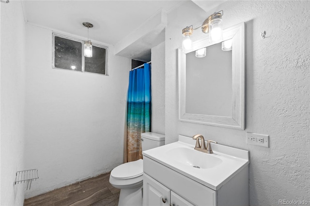 bathroom with vanity, wood-type flooring, a shower with shower curtain, and toilet