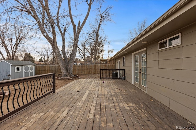 wooden terrace with a storage shed