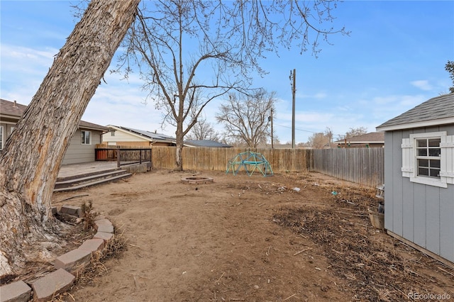 view of yard featuring a wooden deck and an outdoor fire pit