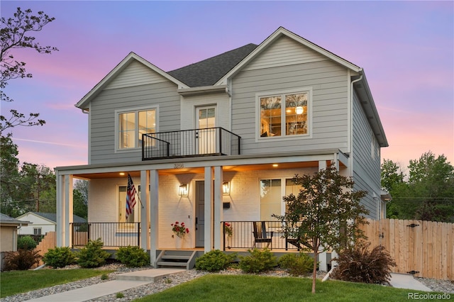 3256 S Corona, Englewood, CO 80113 - view of front facade featuring a porch, a balcony, and roof with shingles