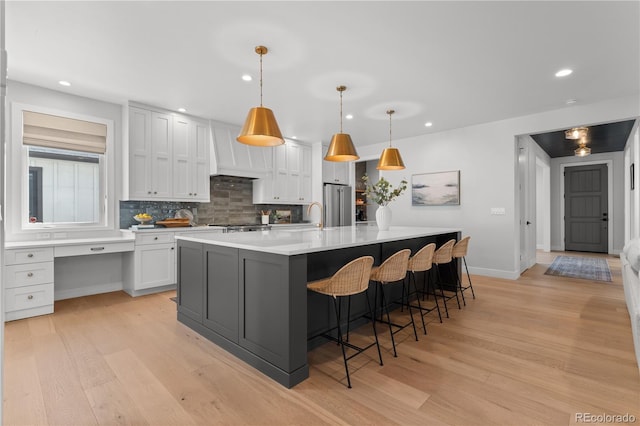 3256 S Corona, Englewood, CO 80113 - kitchen with high quality fridge, light wood-style floors, recessed lighting, tasteful backsplash, and light countertops