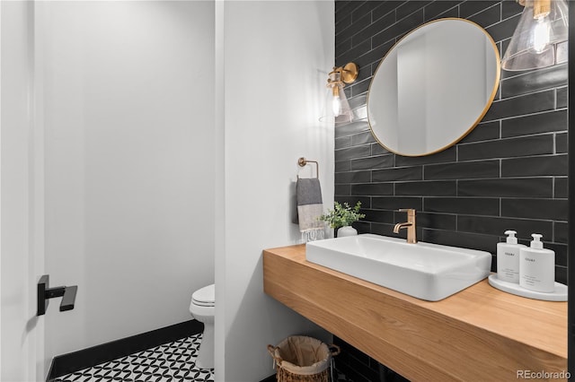 3256 S Corona, Englewood, CO 80113 - half bathroom with decorative backsplash, toilet, vanity, and tile walls