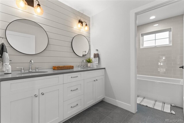 3256 S Corona, Englewood, CO 80113 - bathroom with double vanity, tile patterned flooring, baseboards, and shower / washtub combination