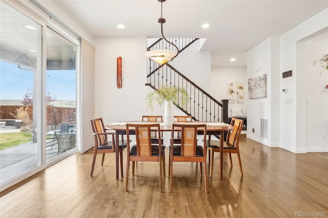 13960 Box Turtle Loop, Parker, CO 80134 - dining area featuring recessed lighting, baseboards, wood finished floors, visible vents, and stairway