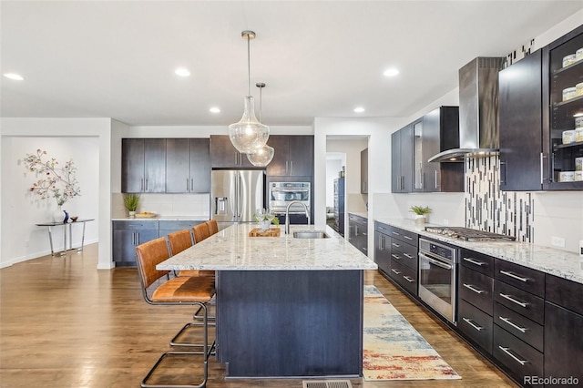 13960 Box Turtle Loop, Parker, CO 80134 - kitchen with wall chimney range hood, decorative backsplash, stainless steel appliances, and dark wood-style flooring