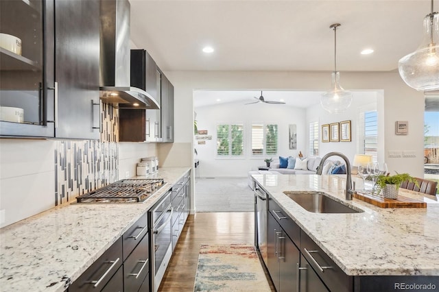 13960 Box Turtle Loop, Parker, CO 80134 - kitchen featuring ceiling fan, appliances with stainless steel finishes, a sink, dark wood finished floors, and a center island with sink