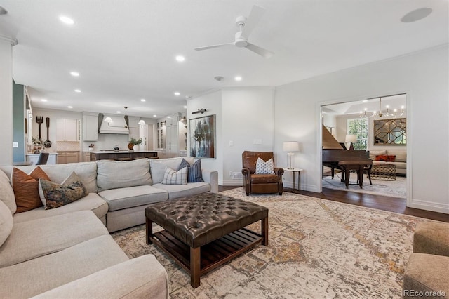 10660 Weathersfield Ct, Highlands Ranch, CO 80129 - living room with recessed lighting, wood finished floors, ceiling fan, crown molding, and a chandelier