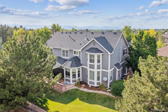10660 Weathersfield Ct, Highlands Ranch, CO 80129 - rear view of property with roof with shingles, a sunroom, and a yard