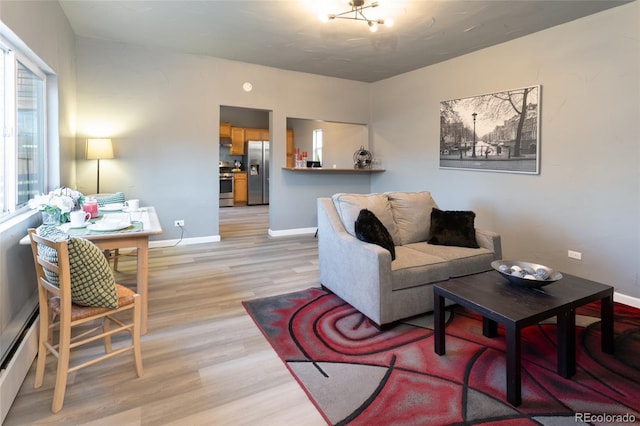 4595 S Lincoln St, Englewood, CO 80113 - living room featuring a baseboard radiator, light wood-type flooring, and baseboards