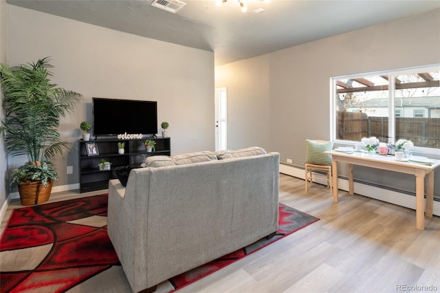 4595 S Lincoln St, Englewood, CO 80113 - living room with visible vents, light wood-style floors, and baseboard heating