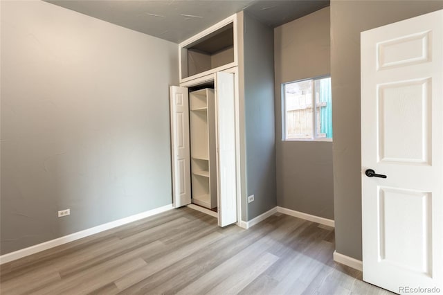 4595 S Lincoln St, Englewood, CO 80113 - unfurnished bedroom featuring light wood finished floors, baseboards, and a closet