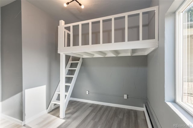 4595 S Lincoln St, Englewood, CO 80113 - stairway with a baseboard heating unit, baseboard heating, baseboards, and wood finished floors