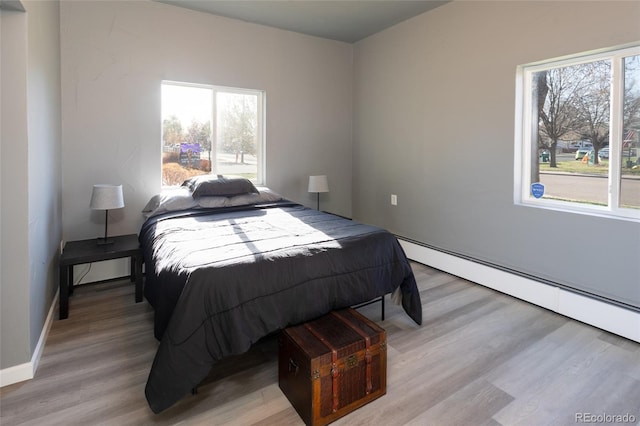 4595 S Lincoln St, Englewood, CO 80113 - bedroom with light wood-style flooring, a baseboard radiator, and baseboards