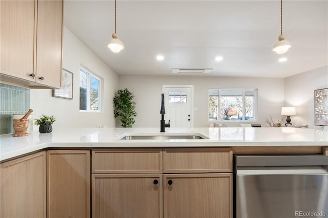 kitchen featuring sink, stainless steel dishwasher, plenty of natural light, and light brown cabinets