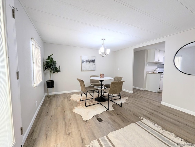 2032 Tulane St, Denver, CO 80260 - dining room featuring light wood-style floors and a chandelier