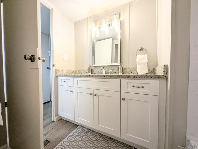 2032 Tulane St, Denver, CO 80260 - bathroom featuring vanity and wood finished floors