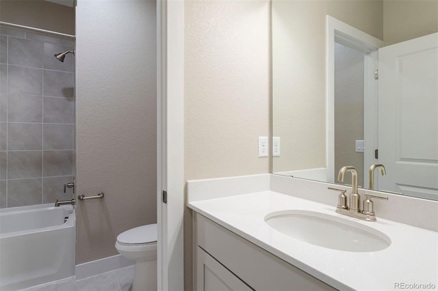 full bathroom featuring tile patterned floors, vanity, toilet, and tiled shower / bath