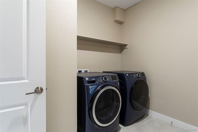 laundry area with light tile patterned flooring and independent washer and dryer