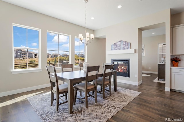 dining space featuring dark hardwood / wood-style flooring and a notable chandelier