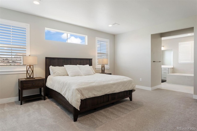 carpeted bedroom featuring connected bathroom